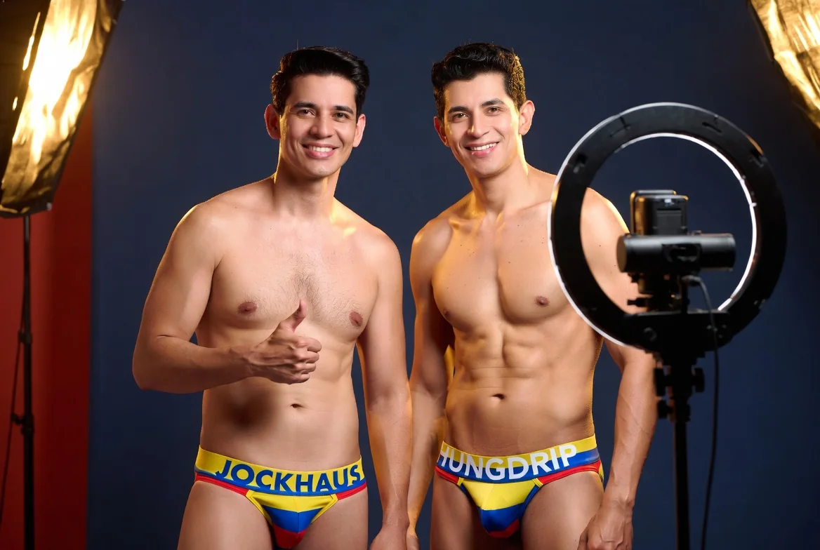 Two attractive Colombian creators smiling in a studio wearing JOCKHAUS and HUNGDRIP underwear